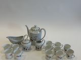 a lot of cups and saucers sitting on a table
