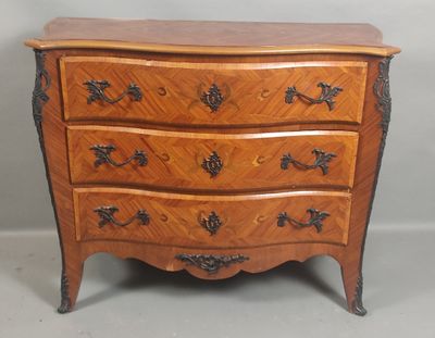 a small wooden chest of drawers on a white floor