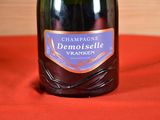 a bottle of champagne on a table with a red cloth