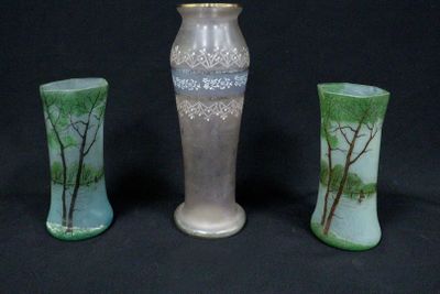 three vases sitting next to each other on a black background