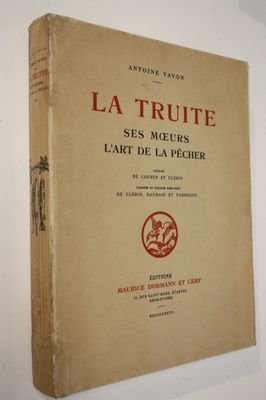 an old book sitting on top of a white table next to a wall