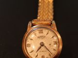an image of a close up of a wrist watch on a table