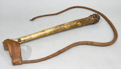 an old wooden stick with a rope on it