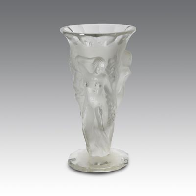 a glass vase with an angel on it on a stand