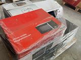 many boxes of electronic equipment on a pallet in a warehouse