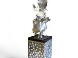 a silver vase with a plant in it on a white background