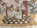 embroidered picture of a woman and a child sitting on a chair