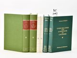 three books sitting next to each other on a white surface