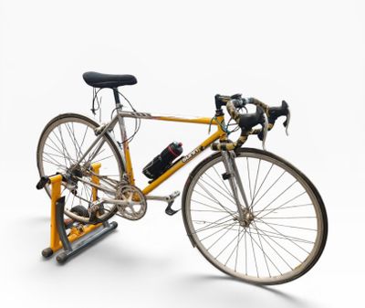 a bike that is sitting on a stand on a white background