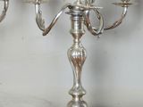 a silver candelab with four candles on it