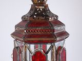 a red glass lantern with a crown on top of it