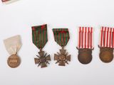 three medals and a medal are on a white surface