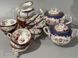 many different types of teapots and saucers on the table