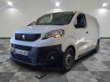 la camionnette blanche est garée dans une grande pièce au sol en damier