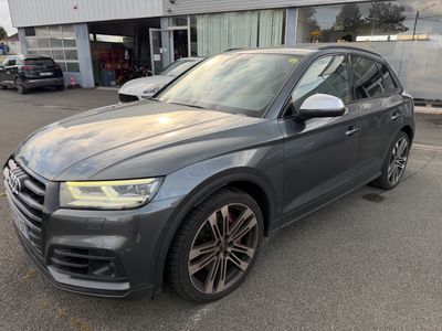 a grey audi suv parked in front of a building
