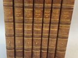 a set of five old books sitting on top of each other