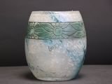 a white vase with a blue and green design on it