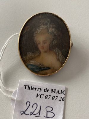 a miniature picture of a woman in a dress on display