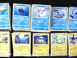 a lot of pokemon cards that are on the table
