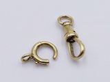 a close up of two gold plated clasps on a white surface