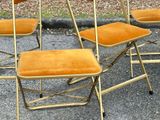 several chairs are lined up in a row on the pavement
