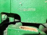 a close up of a green machine with a black handle
