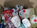 a cardboard box filled with various types of plastic bottles