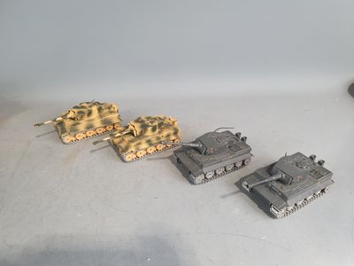 several toy tanks are lined up in a row on a white surface