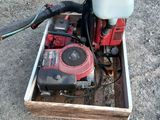 a red and white water pump sitting on a wooden box