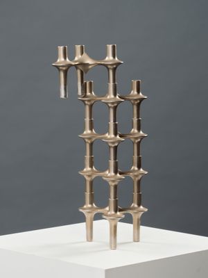 an image of a metal sculpture on top of a white pedestal