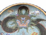 a plate with a dragon on it on a table