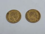 two gold sovereigns, one of which has a head of a man and the other of a woman
