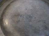 a metal pan with a handle on a table