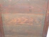 a wooden cabinet with a bird on top of it