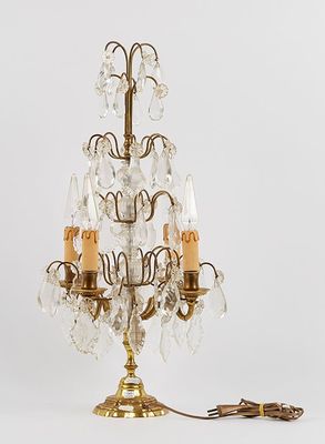 brass and crystal chandelier with three candles on a white background