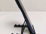 a cell phone sitting on a stand on a table
