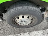 a close up of a tire on a green truck