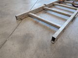 a metal ladder that is laying on the concrete floor