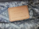 the inside of a handbag with a leather tag on it