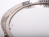 a silver tray with a silver handle on a table