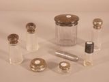 a lot of small glass bottles with silver caps on them