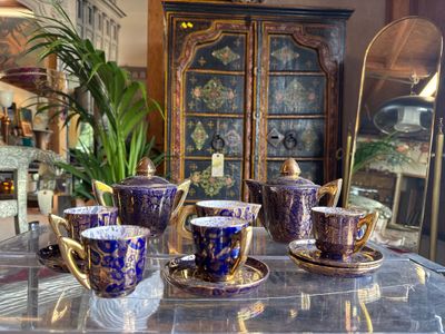 several cups and saucers are sitting on a table in a room