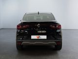 the rear end of a black car in a white room
