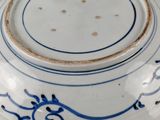 a blue and white bowl with a lid on a table