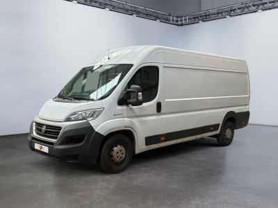the white van is parked inside of a large white room