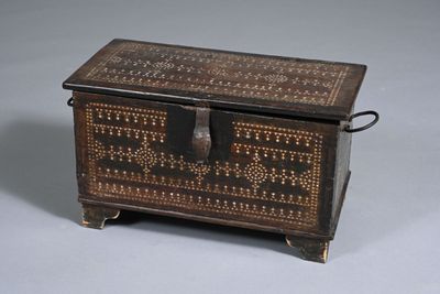 an old wooden box with a decorative design on the lid