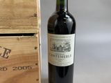 a bottle of wine sitting next to a wooden box