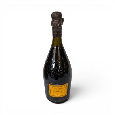 an old bottle of champagne sitting on a white surface