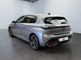 the rear view of a silver car in a showroom