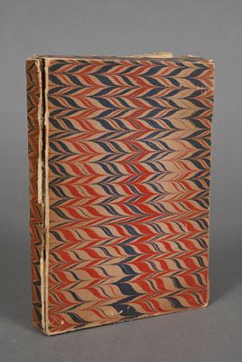 an old book with red, blue and brown designs on it